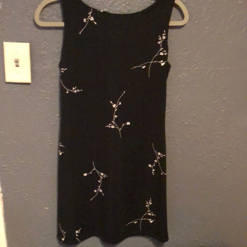 Jalate black dress with white flowers.